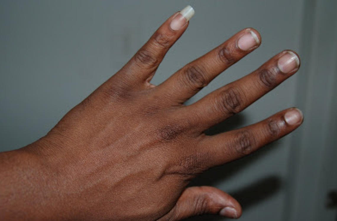 Long unpolished fingernails giving hand