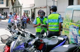 Traffic Police Issuing Stickers to Motor Vehicles Parked outside the Parking Zone