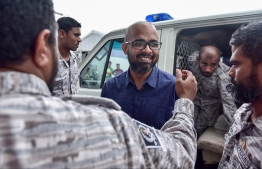 Former Managing Director of Maldives Marketing and Public Relations Corporation (MMPRC) arriving to court escorted by officers from Maldives Correctional Service (MCS).