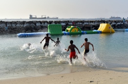 Children pictured playing at Rasfannu Beach in Male' City. PHOTO/MIHAARU
