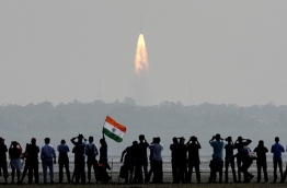 Indian onlookers watch the launch of the Indian Space Research Organisation (ISRO) Polar Satellite Launch Vehicle (PSLV-C37) at Sriharikota on Febuary 15, 2017.
India successfully put a record 104 satellites from a single rocket into orbit on February 15 in the latest triumph for its famously frugal space agency. Scientists who were at the launch in the southern spaceport of Sriharikota burst into applause as the head of India's Space Research Organisation (ISRO) announced all the satellites had been ejected. / AFP PHOTO / ARUN SANKAR