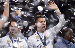 Real Madrid's Portuguese striker Cristiano Ronaldo (R) raises a hand after Real Madrid won the UEFA Champions League final football match between Juventus and Real Madrid at The Principality Stadium in Cardiff, south Wales, on June 3, 2017. / AFP PHOTO / Filippo MONTEFORTE