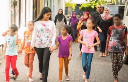 Minister of Gender and Family Zenysha Zaki pictures with children in Hulhumale --