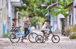 Island life in Raa Atoll Fainu - kids bicycling the streets of the island -- Photo: Hussain Waheed / Mihaaru News