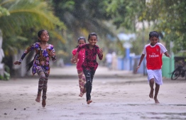 Children running on a road in Fainu: The government has decided to build an airport in the island.
