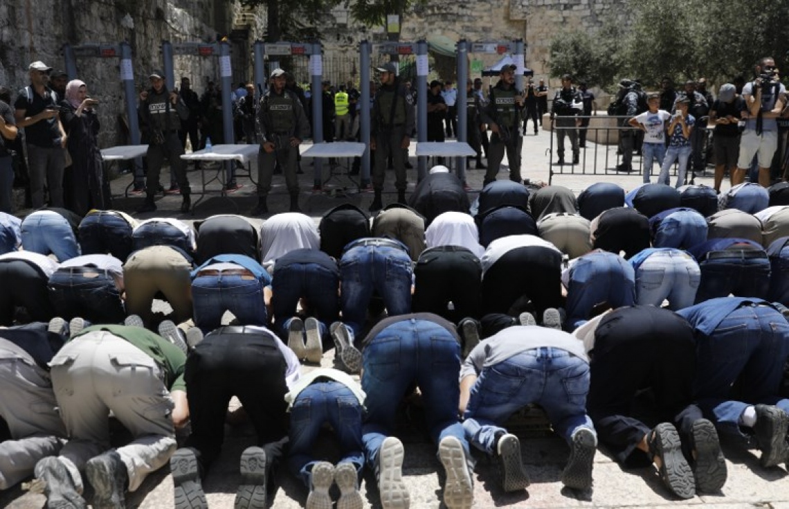 އިޒްރޭލުން އެޅި ފިޔަވަޅުތަކާ ގުޅިގެން އަގްސާ މިސްކިތަށް ވަނުމަށް ދެކޮޅު ހެދި މީހުން ލަޔަންސް ގޭޓުގެ ބޭރުގައި ނަމާދު ކުރަނީ. --ފޮޓޯ:އޭއެފްޕީ