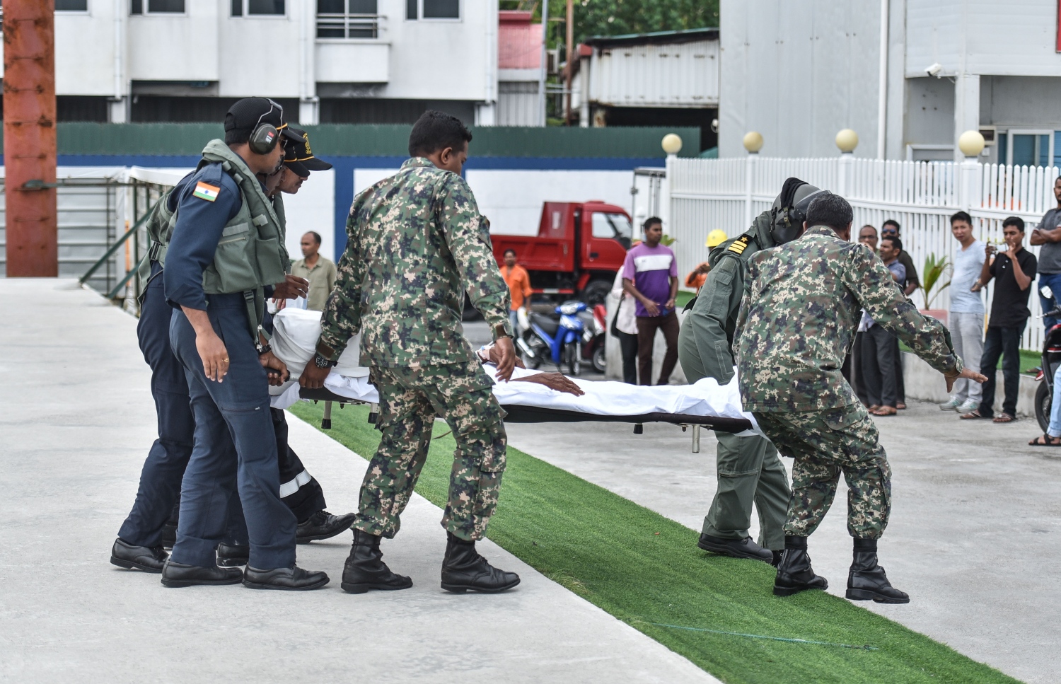 އެމްއެންޑީއެފްގެ ކުރަނގި ހެލިކޮޕްޓަރުގައި ދ.ބަނޑިދޫގައި އޮތް ހާލު ދެރަ ބަލިމީހަކު ވައިގެ މަގުން މާލެ ގެނައުމަށްފަހު، އެބަލިމީހާ އެމްބިއުލާންސަށް އެރުވުމުގެ މަސައްކަތުގައި އޮފިޝަލުން ހަރަކާތްތެރިވަނީ.---ފޮޓޯ:މިހާރު