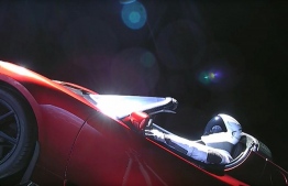This still image taken from a SpaceX livestream video shows "Starman" sitting in SpaceX CEO Elon Musk's cherry red Tesla roadster after the Falcon Heavy rocket delivered it into orbit around the Earth on February 6, 2018.
Screams and cheers erupted at Cape Canaveral, Florida as the massive rocket fired its 27 engines and rumbled into the blue sky over the same NASA launchpad that served as a base for the US missions to Moon four decades ago. / AFP PHOTO / SPACEX / HO / 