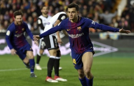 Barcelona's Brazilian midfielder Philippe Coutinho celebrates a goal during the Spanish 'Copa del Rey' (King's cup) second leg semi-final football match between Valencia CF and FC Barcelona at the Mestalla stadium in Valencia on February 8, 2018. / AFP PHOTO / JOSE JORDAN