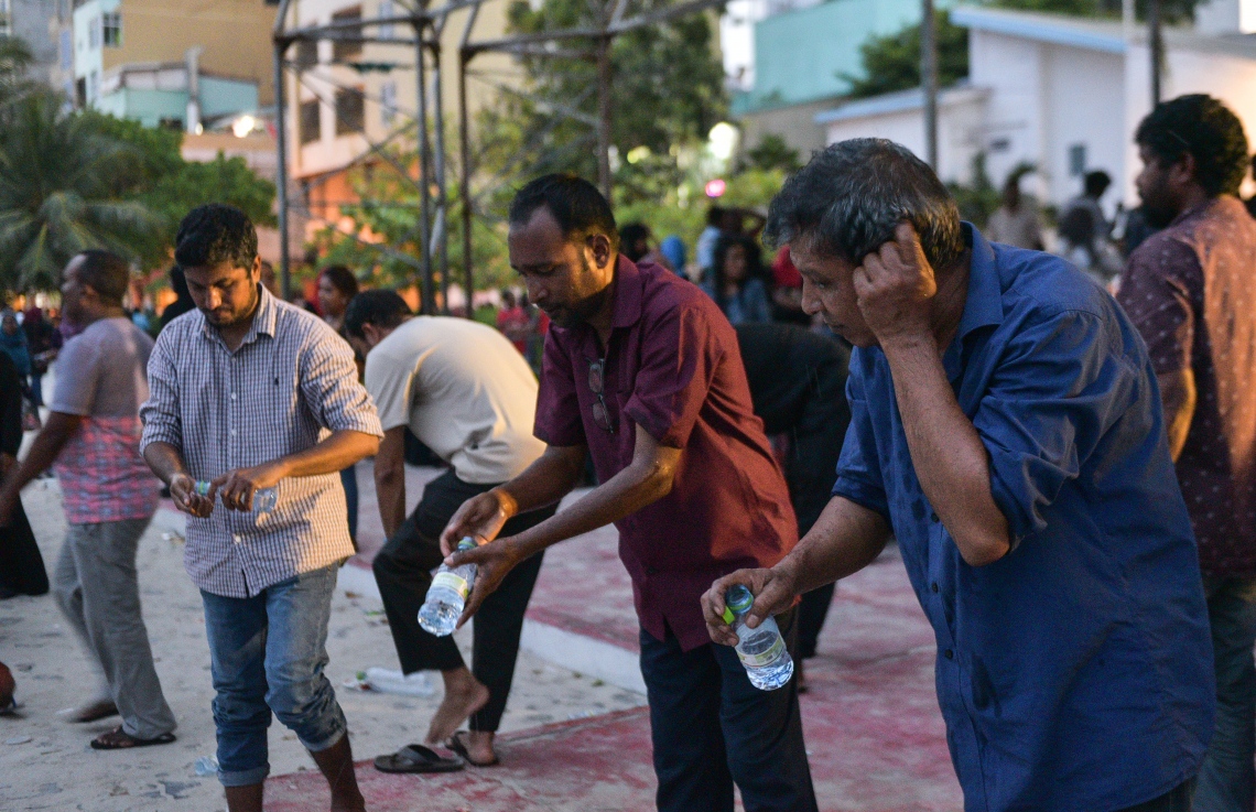 މާލެ: ފެބްރުއަރީ 16، 2018- ސަރުކާރާ ދެކޮޅަށް އިދިކޮޅު ހަރަކާތުން ފަހުގެ ތާރީޚެއްގައި ބާއްވާ ބޮޑު މުޒާހަރާ އަށް ތައްޔާރުވުމަށް "ވޯމްއަޕް މުޒާހަރާ" ގެ ނަމުގައި އެމްޑީޕީގެ ހަރުގެ ކައިރީގައި ކުރިއަށް ގެންދަން އުޅުނު އެއްވުން ފުލުހުން ރޫޅާލުމަށް ފަހު، އެއްވުމުގެ ބައެއް ބައިވެރިން އާޓިފިޝަލް ބީޗް ސަރަހައްދުގައި މަޣްރިބު ނަމާދު ކުރުމަށްޓަކައި ވުލޫ ކުރަނީ.---ފޮޓޯ: ހުސެއިން ވަހީދު/މިހާރު