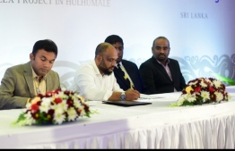 Ahmed Moosa Mohamed (L-2), the Managing Director of SeaLife Global, signs the Hulhumale housing project agreement. FILE PHOTO/MIHAARU