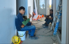 MALE: Two workers at the construction site of Dharumavantha School taking a break. PHOTO: HUSSAIN WAHEED/MIHAARU