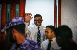 Former VP Adheeb waves to reporters after he exits the Criminal Court following the verdict. MIHAARU PHOTO