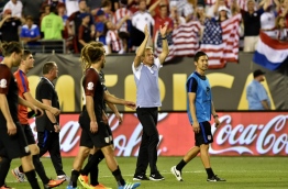 USA's Jurgen Klinsmann (2-R) acknowledges the crowd after defeating Paraguay 1-0 in a Copa America Centenario football tournament match in Philadelphia, Pennsylvania, United States, on June 11, 2016. / AFP PHOTO 