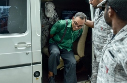 former armory chief Captain Ahmed 'Papa' Fayaz being escorted to the Criminal Court on Sunday. MIHAARU PHOTO/NISHAN ALI