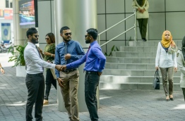 Some civil servants pictured outside the main government office building 'Velaanaage' in the capital Male. MIHAARU PHOTO/NISHAN ALI