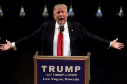 (FILES) This file photo taken on June 18, 2016 shows US Republican presidential candidate Donald Trump speaking during a rally at the Treasure Island Hotel in Las Vegas. A man has been charged for trying to grab a police officer's gun at a Donald Trump rally in Las Vegas so he could kill the presumptive Republican presidential nominee. According to a complaint filed in US District Court in Nevada, Michael Sandford tried to disarm the officer at the June 18 rally at the Mystere Theatre in the Treasure Island Casino before being overpowered./ AFP PHOTO / JOHN GURZINSKI