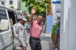 Former defence minister Nazim waves as he is escorted into the Supreme Court on Tuesday. MIHAARU PHOTO/NISHAN ALI
