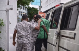 Hussain Humam convicted of killing MP Dr Afrasheem Ali being led to the Supreme Court on June 20, 2016. MIHAARU PHOTO/MOHAMED SHARUHAAN