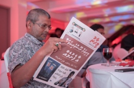 Maldives broadcasting commission president Mohamed Shaheeb pictured with a Mihaaru newspaper during its launching ceremony. MIHAARU FILE PHOTO/MOHAMED SHARUHAAN