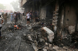The blast, which ripped through a street in the Karrada area where many people go to shop ahead of the holiday marking the end of the Muslim fasting month of Ramadan, killed at least 75 people and also wounded more than 130 people, security and medical officials said. The Islamic State group issued a statement claiming the suicide car bombing, saying it was carried out by an Iraqi as part of the group's "ongoing security operations". / AFP PHOTO / SABAH ARAR