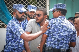Police control protesters gathered near the criminal court for the sentencing of a top opposition lawmaker on Monday. MIHAARU PHOTO/MOHAMED SHARUHAAN