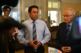 President Yameen (L) speaks to the media as his half brother and ruling party president Maumoon Abdul Gayoom looks on.