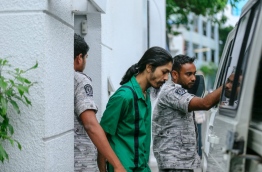 Prison officials leading Murrath away after a Supreme Court hearing. MIHAARU FILE PHOTO/MOHAMED SHARUHAAN