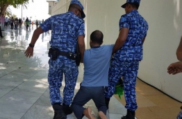Police arrest an opposition worshiper from the Islamic Centre in the capital Male. MIHAARU FILE PHOTO