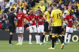 Manchester United's English striker Wayne Rooney (2L) protests at a referee's decision during the English Premier League football match between Watford and Manchester United at Vicarage Road Stadium in Watford, north of London on September 18, 2016. / AFP PHOTO / Adrian DENNIS 