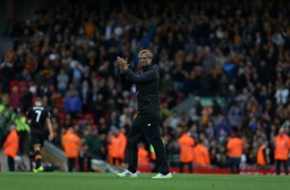 Liverpool's German manager Jurgen Klopp congratulates his players following the English Premier League football match between Liverpool and Hull City at Anfield in Liverpool, north west England on September 24, 2016. / AFP PHOTO / Geoff CADDICK / RESTRICTED TO EDITORIAL USE. No use with unauthorized audio, video, data, fixture lists, club/league logos or 'live' services. Online in-match use limited to 75 images, no video emulation. No use in betting, games or single club/league/player publications. /