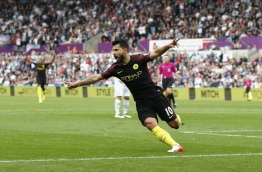 Manchester City's Argentinian striker Sergio Aguero celerbates scoring the opening goal during the English Premier League football match between Swansea City and Manchester City at The Liberty Stadium in Swansea, south Wales on September 24, 2016. / AFP PHOTO / Adrian DENNIS 