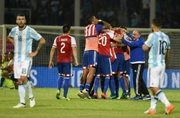 Paraguay's players celebrate their 0-1 team victory against Argentina at the end of their Russia 2018 World Cup football qualifier match in Cordoba, Argentina, on October 11, 2016. / AFP PHOTO / EITAN ABRAMOVICH
