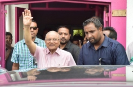 Gayoom waves at the crowd gathered outside the PPM office after he ignored a court order to handover party control to hold a council sit-down last Thursday. MIHAARU PHOTO/MOHAMED SHARUHAAN