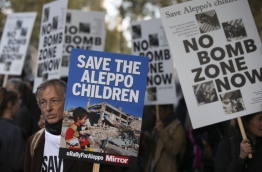 Several campaign groups and charities including Avaaz and Amnesty International organised a rally outside Downing Street in London to call on the British government to set out a plan to protect Syrian children in the embattled Syrian city of Aleppo. Hundreds of wounded civilians were stranded in rebel-held areas of Syria's Aleppo on October 22 after the UN said security concerns had prevented evacuation convoys even as Russia extended a ceasefire into a third day. / AFP PHOTO / Daniel Leal-Olivas