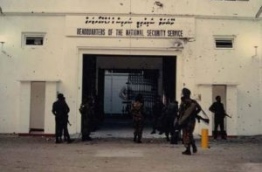 Soldiers of the Maldivian and Indian military overseeing the security outside NSS headquarters, riddled with bullet holes, following the Sri Lankan mercenaries' escape after the coup on November 3, 1988.
