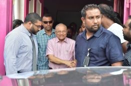 PPM leader Gayoom's son, Ghassan (L) looks on as his father (C) exits the party office after a press conference on Sunday. MIHAARU PHOTO/MOHAMED SHARUHAAN