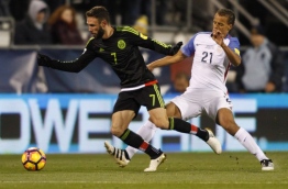 Mexico men's National team defender Miguel Layun (L) works against US men's National defender Timmy Chandler during the 2018 FIFA World Cup qualifying match in Columbus, Ohio on November 11, 2016. / AFP PHOTO / Paul Vernon