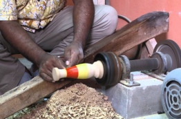 A man demonstrates the craft of lacquer work at Expo Maldives 2015. PHOTO/YOUTUBE