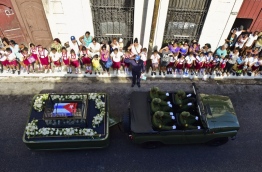 A military jeep carried the ashes of Fidel Castro along streets lined with hundreds of thousands of flag-waving Cubans in Havana on Wednesday, starting a four-day journey to his final resting place across the island. / AFP PHOTO / RONALDO SCHEMIDT