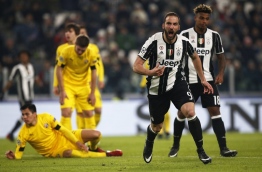 Juventus' forward Gonzalo Higuain from Argentina celebrates after scoring during the UEFA Champions League football match Juventus Vs GNK Dinamo Zagreb on December 7, 2016 at the 'Juventus Stadium' in Turin. / AFP PHOTO / MARCO BERTORELLO