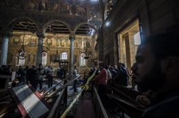 The blast killed at least 25 worshippers during Sunday mass inside the Cairo church near the seat of the Coptic pope who heads Egypt's Christian minority, state media said. / AFP PHOTO / KHALED DESOUKI