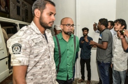 MMPRC's former Managing Director Abdulla Ziyath escorted after a hearing. MIHAARU PHOTO
