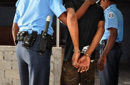 Police taking a man under custody. PHOTO/POLICE