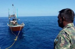 Captain Jamshad Mohamed of MCGS Huravee looks on as the ship tows the Sri Lankan fishing vessel. PHOTO/MNDF