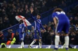 Chelsea's Brazilian-born Spanish striker Diego Costa (C) waves to supporters as he is substituted during the English Premier League football match between Chelsea and Hull City at Stamford Bridge in London on January 22, 2017. / AFP PHOTO / Adrian DENNIS / RESTRICTED TO EDITORIAL USE. No use with unauthorized audio, video, data, fixture lists, club/league logos or 'live' services. Online in-match use limited to 75 images, no video emulation. No use in betting, games or single club/league/player publications. /