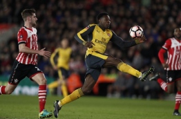 Arsenal's English striker Danny Welbeck (C) scores his team's second goal during the English FA Cup fourth round football match between Southampton and Arsenal at St Mary's in Southampton, southern England on January 28, 2017. / AFP PHOTO / Adrian DENNIS / RESTRICTED TO EDITORIAL USE. No use with unauthorized audio, video, data, fixture lists, club/league logos or 'live' services. Online in-match use limited to 75 images, no video emulation. No use in betting, games or single club/league/player publications. /