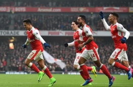 Arsenal's Chilean striker Alexis Sanchez (L) celebrates with teammates after scoring the opening goal of the English Premier League football match between Arsenal and Hull City at the Emirates Stadium in London on February 11, 2017. / AFP PHOTO / Glyn KIRK / RESTRICTED TO EDITORIAL USE. No use with unauthorized audio, video, data, fixture lists, club/league logos or 'live' services. Online in-match use limited to 75 images, no video emulation. No use in betting, games or single club/league/player publications. /