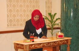 Judge Mariyam Waheed signs her oath after swearing-in as a judge. PHOTO: MARIYAM WAHEEDA/FACEBOOK