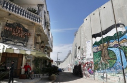 Secretive British street artist Banksy opened a hotel next to Israels controversial separation wall in Bethlehem on Friday, his latest artwork in the Palestinian territories. / AFP PHOTO / THOMAS COEX